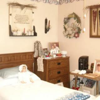 A cozy and traditionally decorated bedroom with vintage furnishings.