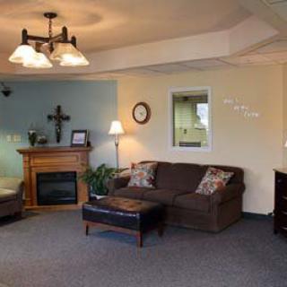A cozy living room with a sofa, fireplace, and decorative elements.