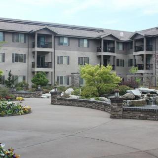 A residential apartment complex with landscaped surroundings.
