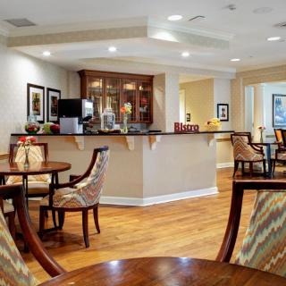 A cozy indoor lounge with elegant seating arrangements and wooden flooring.