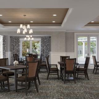 A spacious dining room with elegant furniture and a chandelier.