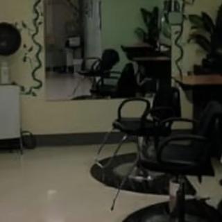 Interior of a hair salon with styling chairs and mirrors.