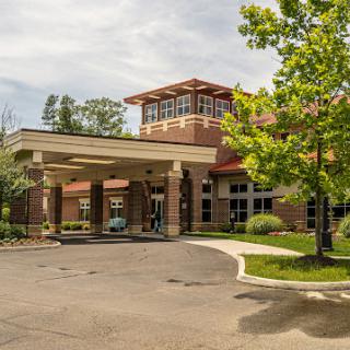 A welcoming entrance to a well-designed building surrounded by greenery.