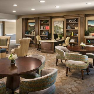 A cozy lounge area with comfortable seating and bookshelves.
