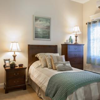A cozy bedroom with classic furniture and soft lighting.