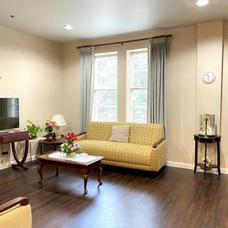A cozy living room with classic furniture and warm lighting.
