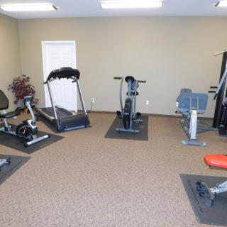 A small gym area with various exercise equipment.