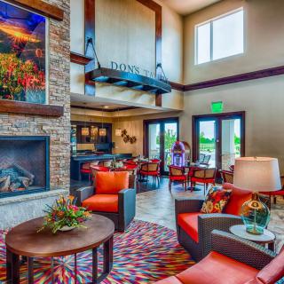 A modern living room with a vibrant interior, featuring a cozy seating area and a fireplace.