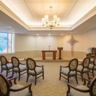 A small chapel with arranged seating and an altar.