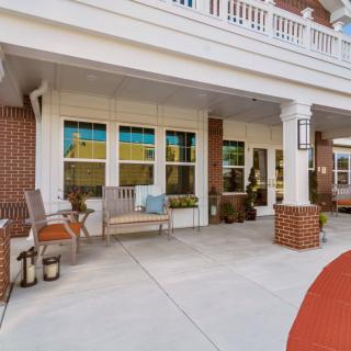 A welcoming porch with seating and decorative elements.