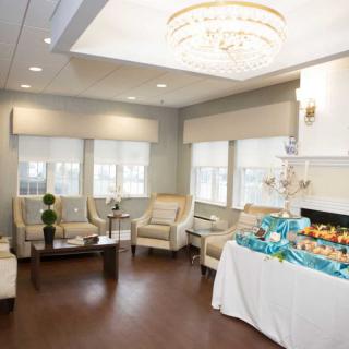 A modern living room with elegant furniture and a decorative chandelier.