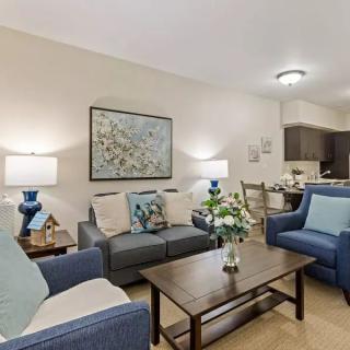 A cozy living room with modern furniture and decorative elements.