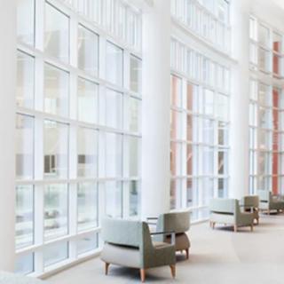 A spacious, modern interior with large windows and comfortable seating.
