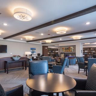 A modern lounge area with comfortable seating, tables, and stylish lighting.
