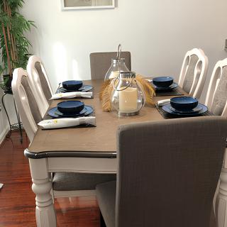 A well-arranged dining table with blue dishes and decorative candles.