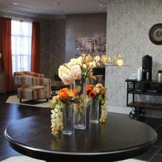 A stylish living room with floral arrangement on a round table.