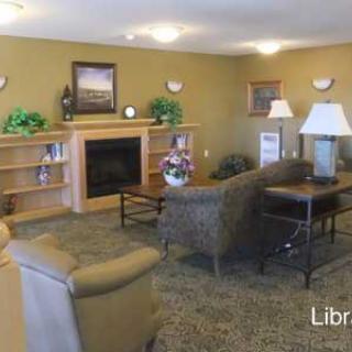 A cozy living room with a fireplace, comfortable seating, and decorative elements.