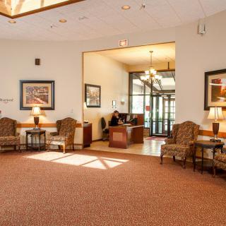 A well-lit lobby with comfortable seating and a reception desk.