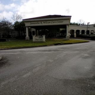 An overview of the entrance to a building, set against a cloudy sky.