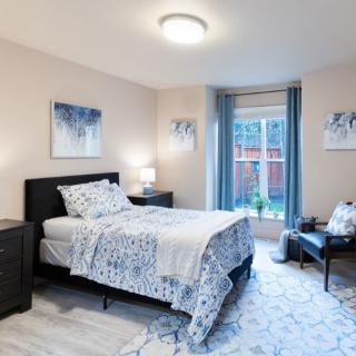 A modern and cozy bedroom with stylish decor and ample natural light.