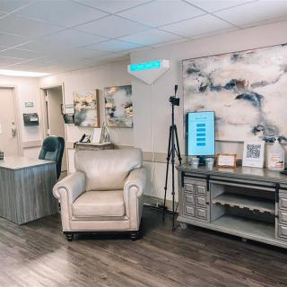 A modern waiting room with comfortable seating and stylish artwork.