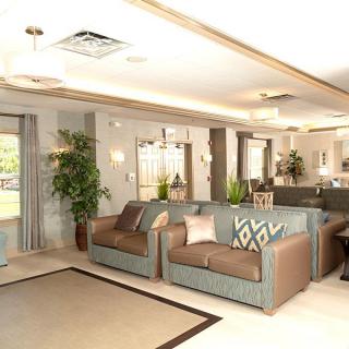 A modern and spacious living room with elegant furniture and neutral color accents.