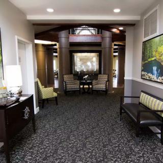 A modern lobby area with comfortable seating and artwork on the walls.