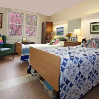 A cozy bedroom with two neatly made beds and warm lighting.