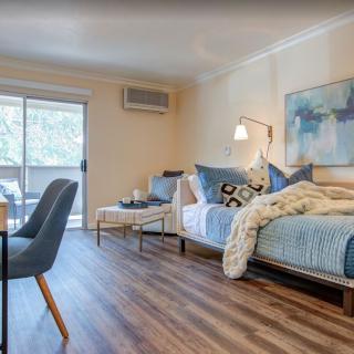 A cozy and modern living room with stylish furniture and wooden flooring.