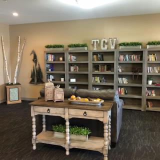 A cozy living room with a bookshelf and decorative elements.