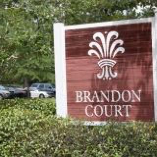 Entrance sign for Brandon Court surrounded by greenery.