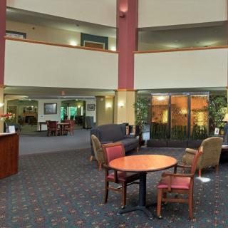 A modern lobby with comfortable seating and a carpeted floor.