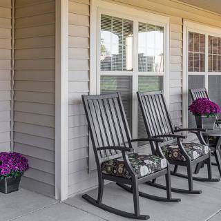 A cozy porch with rocking chairs and vibrant flowers.