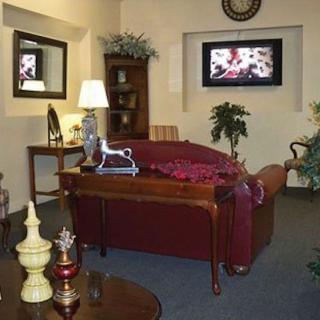 A cozy living room with a sofa, lamp, and decorative elements.