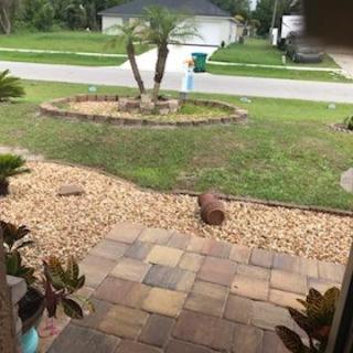 A well-maintained front yard with a paved path and landscaped garden.