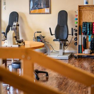 A physical therapy room equipped with exercise machines and rehabilitation tools.