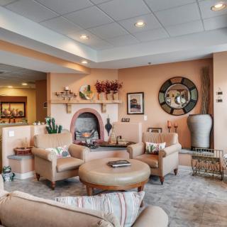 A cozy and elegantly decorated living room with a fireplace and modern furnishings.