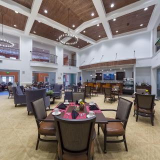 A spacious, modern dining area featuring elegant seating and sophisticated lighting.