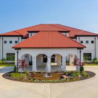 A stunning residential building featuring a welcoming entrance and beautifully landscaped surroundings.