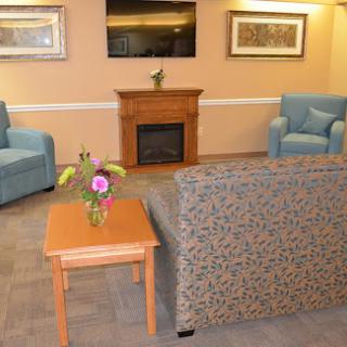 A cozy living room with comfortable seating, a fireplace, and decorative elements.