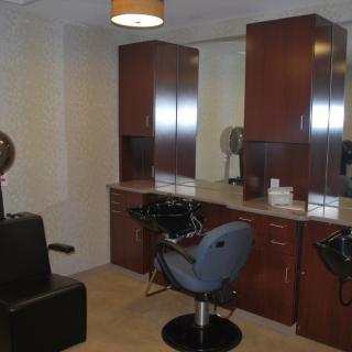A modern hair salon interior with styling stations and chairs.