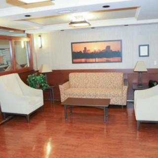 A well-lit lobby area featuring comfortable seating and a warm color palette.