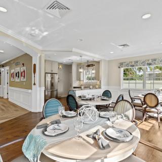 A beautifully decorated dining room with a stylish table setting and modern furnishings.