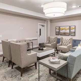 A modern living room with stylish furniture and warm lighting.