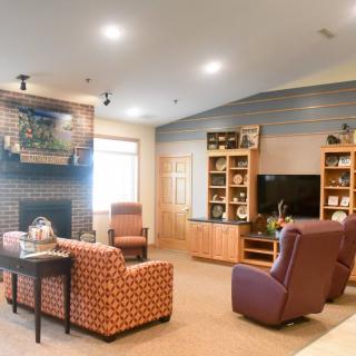 A cozy living room with a fireplace and comfortable seating arrangement.