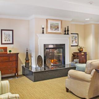A cozy living room with a fireplace and comfortable seating.