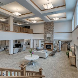 A modern and spacious lobby designed for comfort and relaxation, featuring elegant furnishings and a cozy fireplace.
