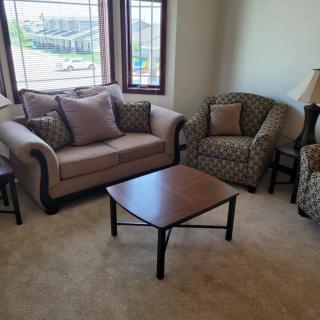 A cozy living room with a sofa, armchairs, and a coffee table.