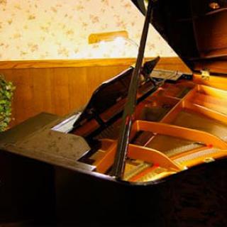 A grand piano in a warmly lit room.