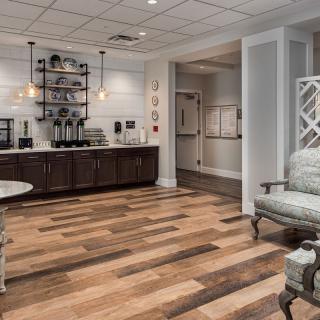 A cozy waiting room with a coffee station and comfortable seating.